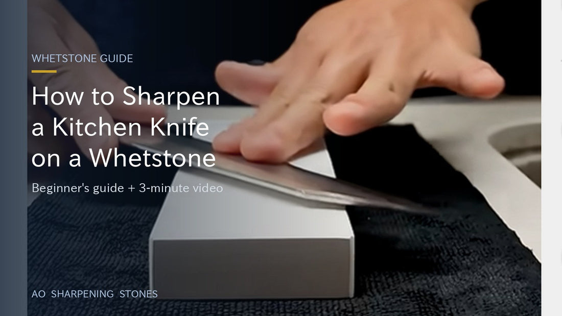Hands sharpening a kitchen knife flat against a whetstone
